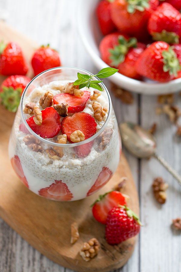 Quinoa and strawberry parfait with spoon with strawberry background