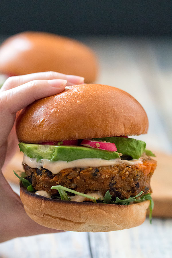 Quinoa black bean burgers in hand