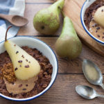 two bowls healthy chocolate porridge with poached pear with Linwoods seeds